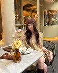 Linen‑blend sleeveless dress with 3D paisley embroidery.