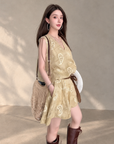 Linen‑blend sleeveless dress with 3D paisley embroidery.