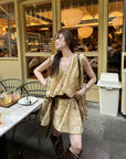 Linen‑blend sleeveless dress with 3D paisley embroidery.