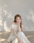 Asymmetric off-shoulder ruffle-drape top