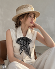 Chic polo-style tweed vest with a matching scarf.