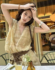 Linen‑blend sleeveless dress with 3D paisley embroidery.