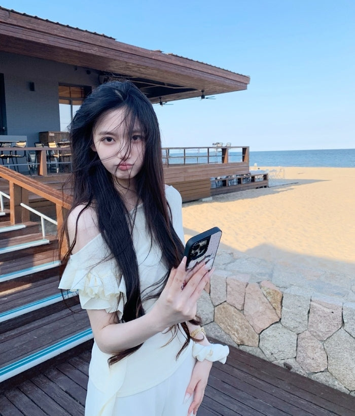 Asymmetric off-shoulder ruffle-drape top