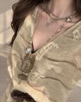 Linen‑blend sleeveless dress with 3D paisley embroidery.