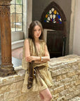 Linen‑blend sleeveless dress with 3D paisley embroidery.