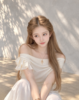Asymmetric off-shoulder ruffle-drape top