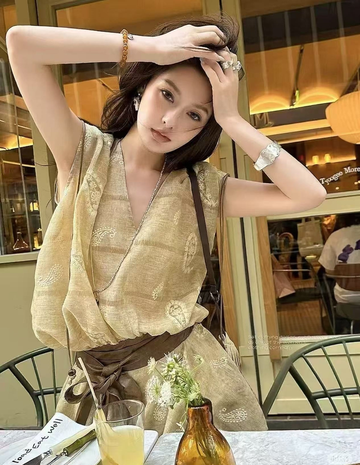 Linen‑blend sleeveless dress with 3D paisley embroidery.