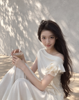 Asymmetric off-shoulder ruffle-drape top
