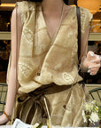 Linen‑blend sleeveless dress with 3D paisley embroidery.