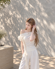 Asymmetric off-shoulder ruffle-drape top